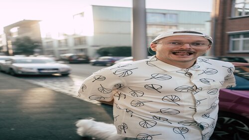 Foto von Jannis Johannmeier draußen mit gemustertem Hemd, lächelnd 